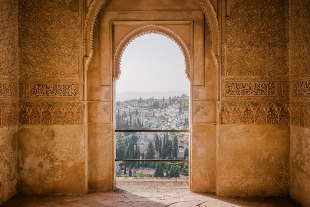 A peek out of a golden window at the Alhambra in Granada, Spain.