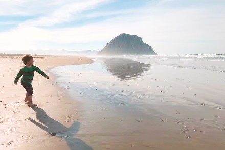 The world's cutest toddler, running along a beach